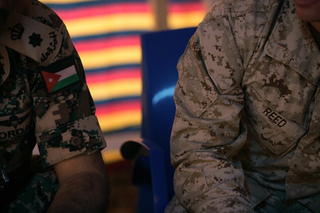 A Marine sits next to his Jordanian counterpart during a meet and greet on the first day of Exercise Eager Lion 2013 at Camp Titin, Jordan, June 9, 2013.