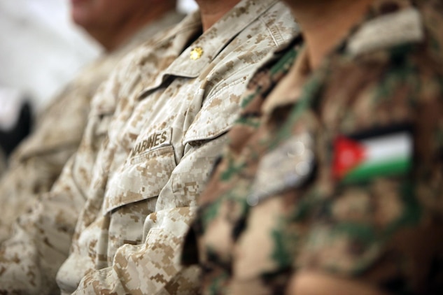 A Marine sits next to his Jordanian counterpart during a brief at Camp Titin, Jordan, June 9, 2013.