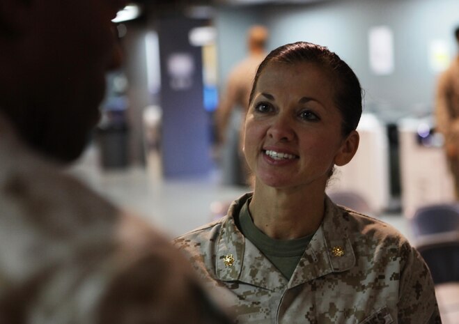 Maj. Sally A. Falco, a Detroit native, visits with Marines and sailors after she was welcomed to the United States Marine Corps Forces Central Command (Forward) team, Aug. 15 in a change of a command ceremony.  Falco replaced Maj. Melanie R. Bell-Carter as the MARCENT (FWD), Headquarters Company commanding officer. 