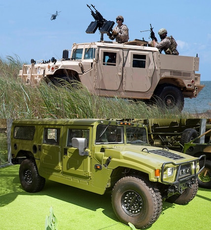 A Chinese Eastwind EQ2050 vehicle (green) bears a striking resemblance to an original U.S. military Humvee (top), showing the results of tampering with and reverse engineering vital equipment. 