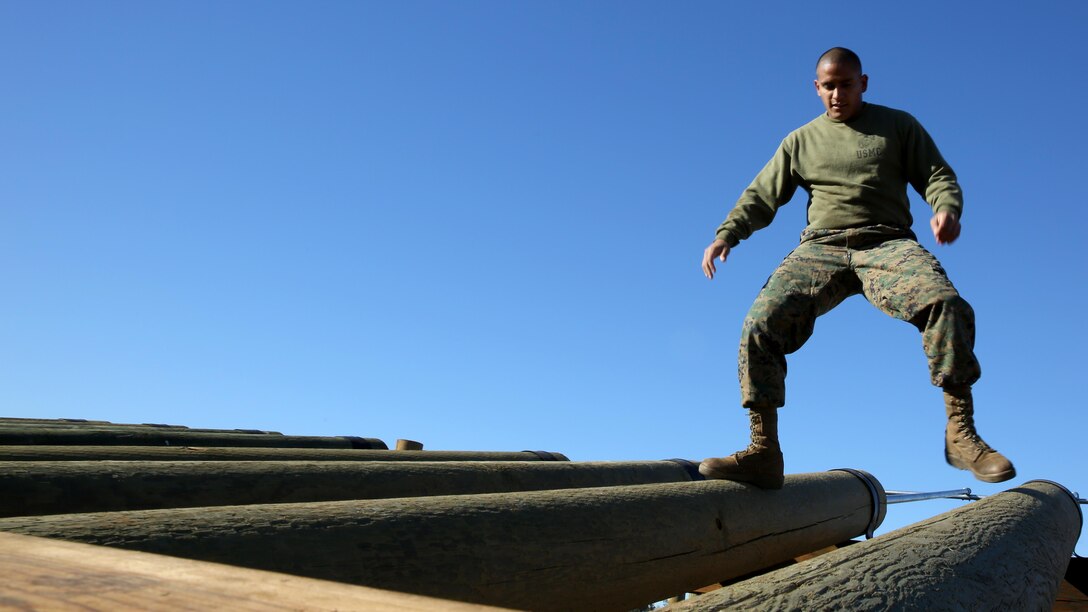 Sgt. Gerardo Laurido, section head at motor transportation with Marine Wing Support Squadron (MWSS) 373, maneuvers over an obstacle after the ribbon-cutting ceremony opening the obstacle course aboard Marine Corps Air Station Miramar, Calif., Jan. 6. Marines participated in a post-opening training session with the course. 