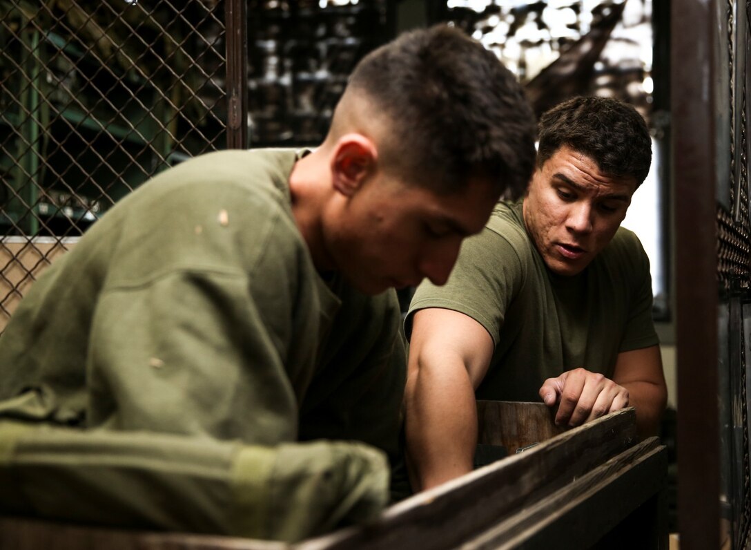 Corporal Rene Gonzalez, left, data network specialist, and Lance Cpl. Carlos D. Vassallo, field radio operator, both with the 15th Marine Expeditionary Unit, pack radio equipment in preparation for a communications exercise aboard Camp Pendleton, Calif., on Jan. 6, 2014. The exercise is designed to prepare the 15th MEU Marines for Exercise Iron Fist. (U.S. Marine Corps photo by Cpl. Emmanuel Ramos/Released)