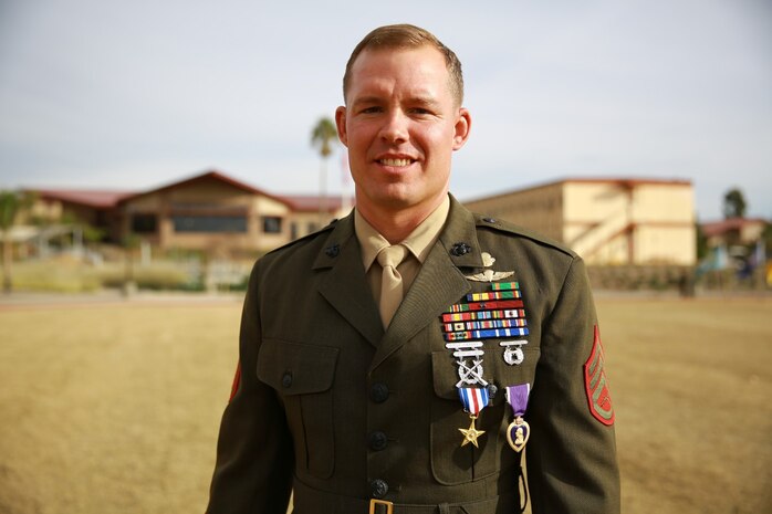 Staff Sgt. Timothy Williams, a section leader with 1st Reconassiance Battalion, recieves the Silver Star Medal and Purple Heart from Lt. Gen. John Toolan, commanding general of I Marine Expeditionary Force, during an award ceremony held at Camp Las Flores, Marine Corps Base Camp Pendleton, Calif., Jan. 7, 2014. Williams, a native of Hudson, Mich., was recognized for his heroic actions in Afghanistan when he maintained a tactical advantage while being ambushed by a larger enemy force. Williams helped save the lives of multiple Marines and destroyed several enemy positions during the 10 hour attack. (U.S Marine Corps photo by Lance Cpl. Jonathan Boynes/released)
