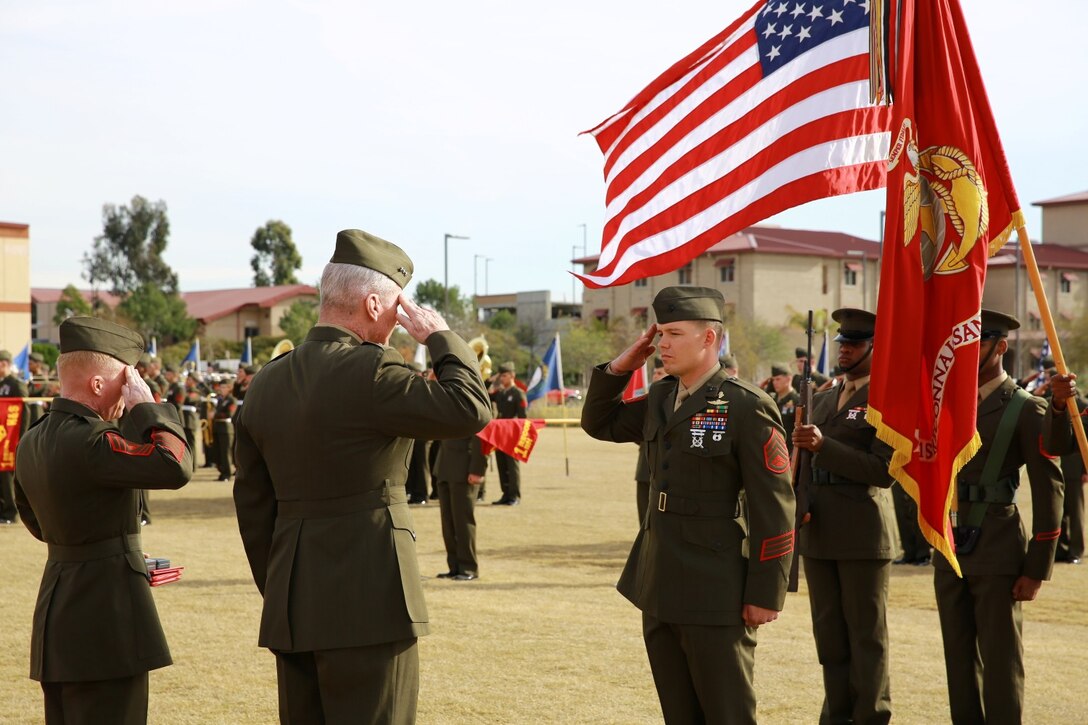 Staff Sgt. Timothy Williams, middle, a section leader with 1st Reconnaissance Battalion, salutes Lt. Gen John Toolan, second from left, during an award ceremony when he received the Silver Star Medal and Purple at Camp Las Flores, Marine Corps Base Camp Pendleton, Calif., Jan. 7, 2014. Williams, a native of Hudson, Mich., was recognized for his heroic actions in Afghanistan when he maintained a tactical advantage while being ambushed by a larger enemy force. Williams helped saved the lives of multiple Marines and destroyed several enemy positions during the 10 hour attack. (U.S Marine Corps photo by Lance Cpl. Jonathan Boynes/released)