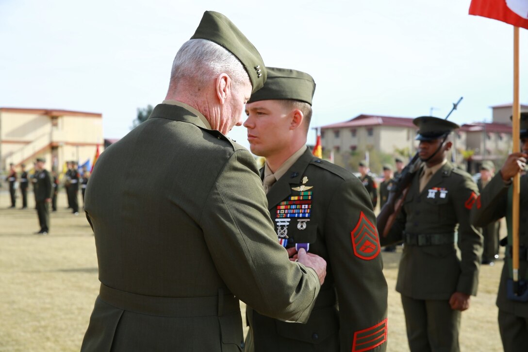 Lieutenant Gen. John Toolan, commanding general of I Marine Expeditionary Force, pins the Purple Heart on Staff Sgt. Timothy Williams, a section leader with 1st Reconnaissance Battalion, during an award ceremony when he received the Silver Star Medal and Purple Heart at Camp Las Flores, Marine Corps Base Camp Pendleton, Calif., Jan. 7, 2014. Williams, a native of Hudson, Mich., was recognized for his heroic actions in Afghanistan when he maintained a tactical advantage while being ambushed by a larger enemy force. Williams helped save the lives of multiple Marines and destroyed several enemy positions during the 10 hour attack. (U.S Marine Corps photo by Lance Cpl. Jonathan Boynes/released)
