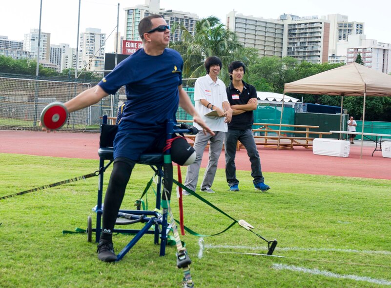 Retired Army Cpl. Javier Rodriguez throws a discus during the seated discus throw event at the track and field competition of the inaugural Wounded Warrior Pacific Invitational in Honolulu, Hawaii, Jan. 8, 2014. The WWPI is one in a series of adaptive athletic events leading up to the 2014 Warrior Games. Adaptive athletic reconditioning helps wounded warriors build strength and endurance while drawing inspiration from their teammates. It also helps the athletes having greater self-esteem, lower stress levels and fewer secondary medical conditions.  (U.S. Air Force photo/Tech. Sgt. Terri Paden)