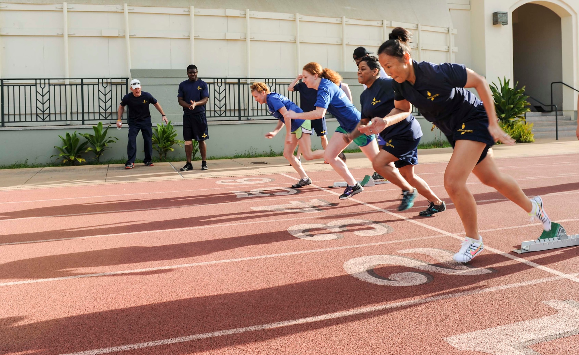 Participants take off for the women’s 100-meter dash event during the track and field competition of the inaugural Wounded Warrior Pacific Invitational in Honolulu, Hawaii, Jan. 8, 2014. The week-long event is the largest joint-service competition to take place outside of the annual Warrior Games. The Pacific Invitational is an Olympic-style competition in which the activities are modified to meet the abilities of the warriors, and is open to service members with upper-body, lower-body and spinal cord injuries, serious illnesses, traumatic brain injuries, visual impairment and post-traumatic stress disorder.  (U.S. Air Force photo/Tech. Sgt. Terri Paden)