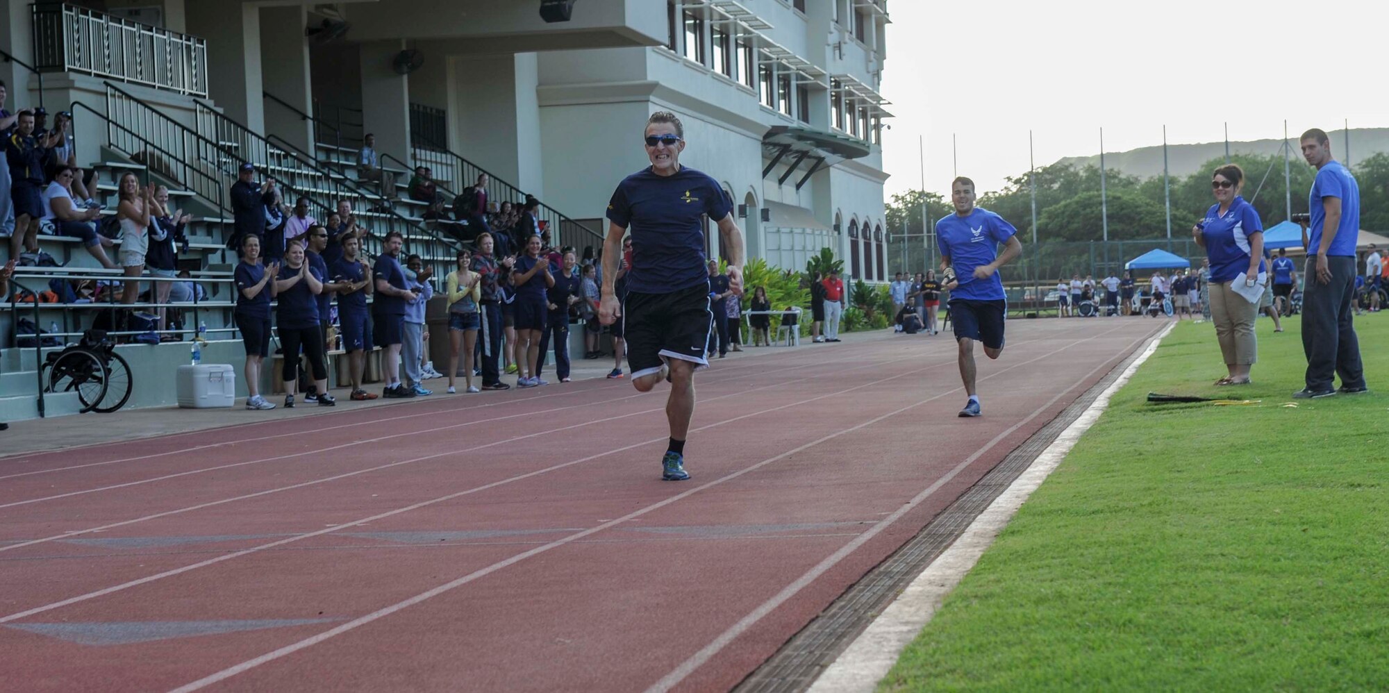 Retired Navy Lt. Steven Miller and retired Staff Sgt. Daniel Crane race to the finish line during the 800- meter race during the track and field competition of the inaugural Wounded Warrior Pacific Invitational in Honolulu, Hawaii, Jan. 8, 2014. The WWPI will pit more than 120 warriors against each other in cycling, seated volleyball, swimming, wheelchair basketball and track and field. (U.S. Air Force photo/Tech. Sgt. Terri Paden)
