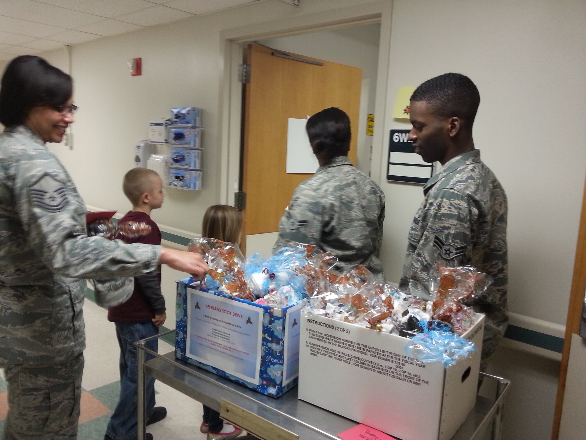 Airman 1st Class Nicholas Bush, 2nd Medical Support Squadron, far right, and members of the 2nd MDSS visit with Veterans at the Overton Brooks VA Medical Center in Shreveport, La., Dec. 14, 2013. As part of the 2nd MDSS’ Airman Leadership Project, Bush created the Veteran’s Sock Drive to pass out more than 100 pairs of socks and hand written cards to Veteran’s in Shreveport. (Courtesy photo)