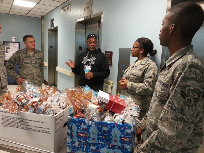Airman 1st Class Nicholas Bush, 2nd Medical Support Squadron, far right, and members of the 2nd MDSS are greeted by Reginald Hardy, Chief of Voluntary Service at the Overton Brooks VA Medical Center in Shreveport, La., Dec. 14, 2013. Bush worked with Hardy to bring gifts and warm wishes to the Veterans who could not be with family for the holidays. (Courtesy photo)
