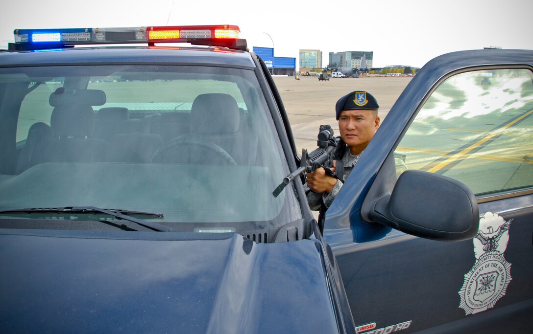 U.S. Air Force Airman 1st Class William DeGuzman, 129th Security Forces specialist, performs integrated base defense measures during a training scenario at the 129th Rescue Wing, Moffett Federal Airfield, Calif., Nov. 14, 2013.  (U.S. Air National Guard photo by Tech. Sgt. Ray Aquino/RELEASED)