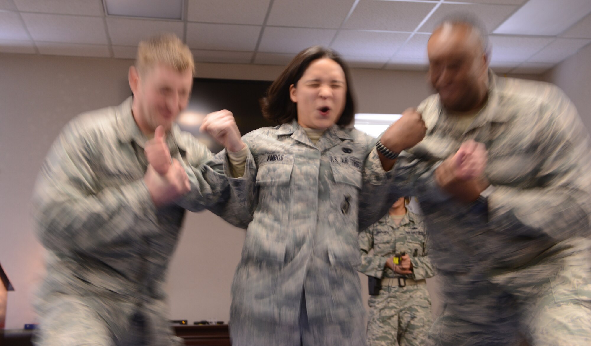 Senior Airman Jaclyn Ambos, 366th Security Forces Squadron desk sergeant, reacts to exposure from a TASER X26 during equipment training Dec. 10, 2013, at Mountain Home Air Force Base, Idaho. The exposure is a five-second cycle that blocks the sensory and motor nerves causing an individual’s muscles to contract. (U.S. Air Force photo by Airman 1st Class Malissa Lott/ RELEASED)
