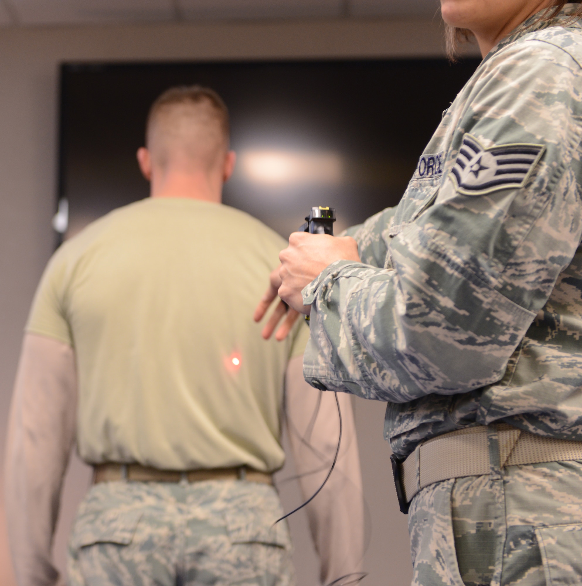 Staff Sgt. Giselle Janousek, 366th Security Forces Squadron trainer, demonstrated the use of the TASER X26 at Mountain Home Air Force Base, Idaho, Dec. 10, 2013. The TASER X26 is used by Defenders as a non-lethal tool to prevent individuals from causing harm to a responding officer. (U.S. Air Force photo by Airman 1st Class Malissa Lott/ RELEASED)
