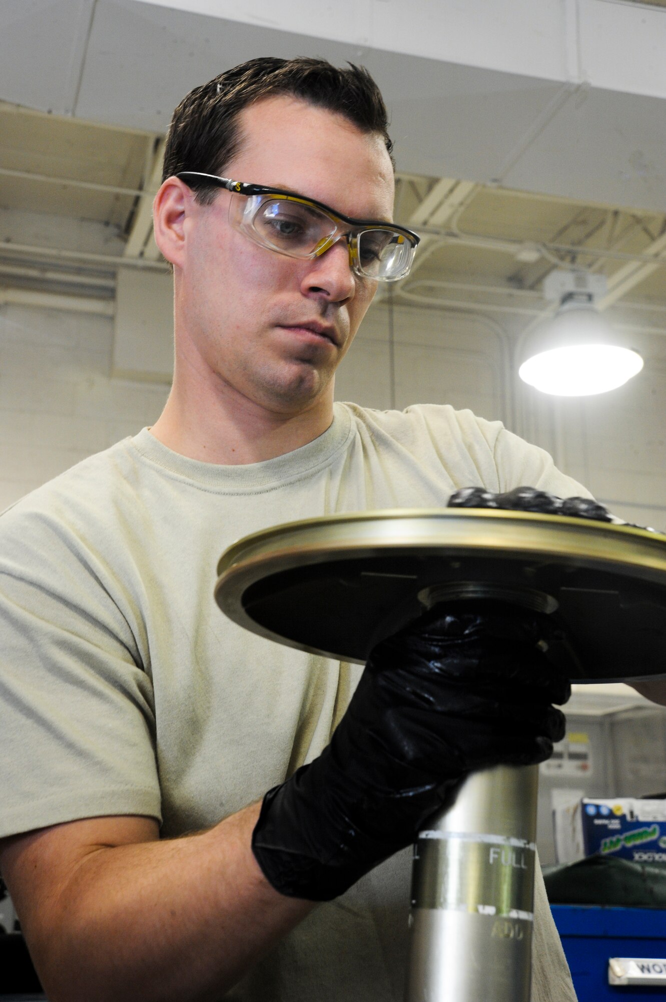 U.S. Air Force Staff Sgt. James Boslooper, 355th Component Maintenance Squadron hydraulic systems craftsman, screws on a face plate for a bootstrap reservoir at Davis-Monthan Air Force Base, Ariz., Jan. 7, 2014. A bootstrap reservoir stores hydraulic fluid for the A-10 Thunderbolt II until the aircraft needs it for landing and other ground movements. (U.S. Air Force photo by Senior Airman Sivan Veazie/Released)