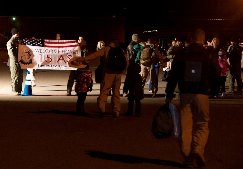 A member of the 15th Airlift Squadron is greeted by his family Jan. 6, 2014, at Joint Base Charleston - Air Base, S.C. More than 80 Airmen from the 15th AS returned from a 60-day deployment to Southwest Asia. (U.S. Air Force photo/Staff Sgt. William O’Brien)