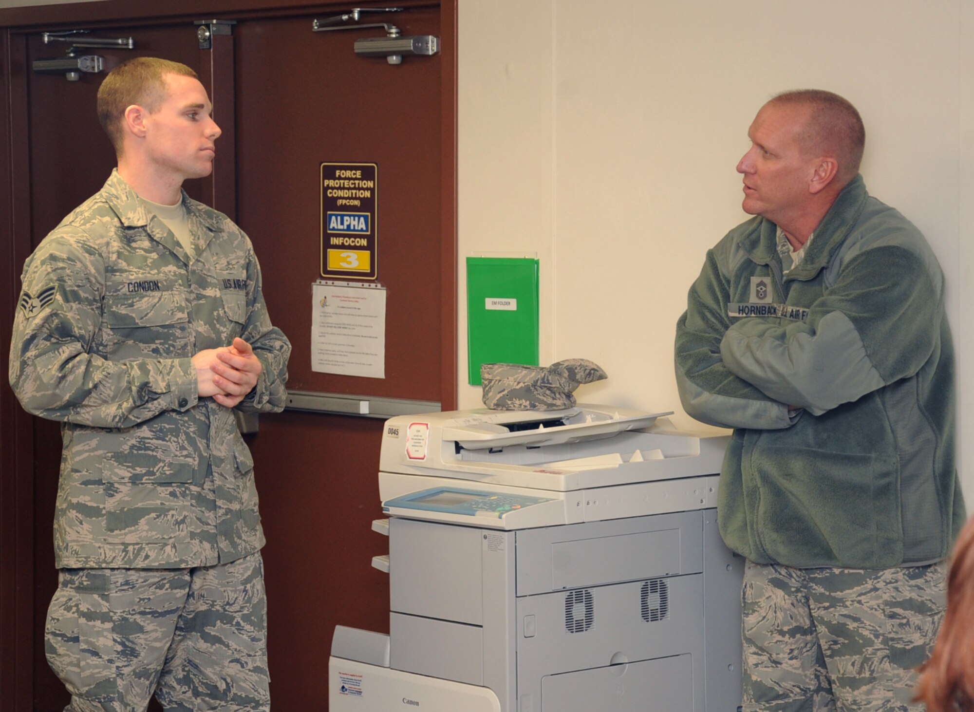 Airman 1st Class Michael Condon, left, 2nd Comptroller Squadron customer service technician, briefs Chief Master Sgt. Brian Hornback, Air Force Global Strike Command command chief, during his tour of the 2nd Bomb Wing on Barksdale Air Force Base, La., Jan. 7, 2014. Although he will be retiring later this year, Hornback plans to stay in the local area due to the many ties and friendships he has created over the years. (U.S. Air Force photo/Staff Sgt. Sean Martin)