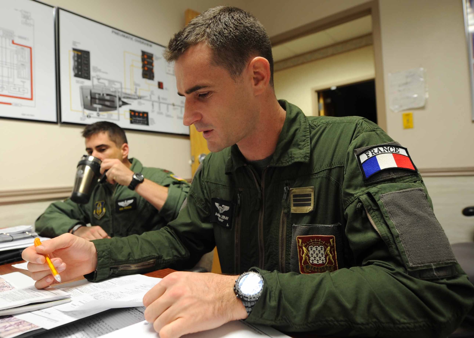 ALTUS AIR FORCE BASE, Okla. – French air force Capt. Aurélien Leray begins his morning by drinking coffee and studying for his upcoming simulated flight Oct. 25, 2013. Leray has more than 1,200 hours of flying experience on the French C-135fr Stratotanker and is now learning the U.S. standards for flying the KC-135 Stratotanker. (U.S. Air Force photo by Senior Airman Levin Boland/Released) 
