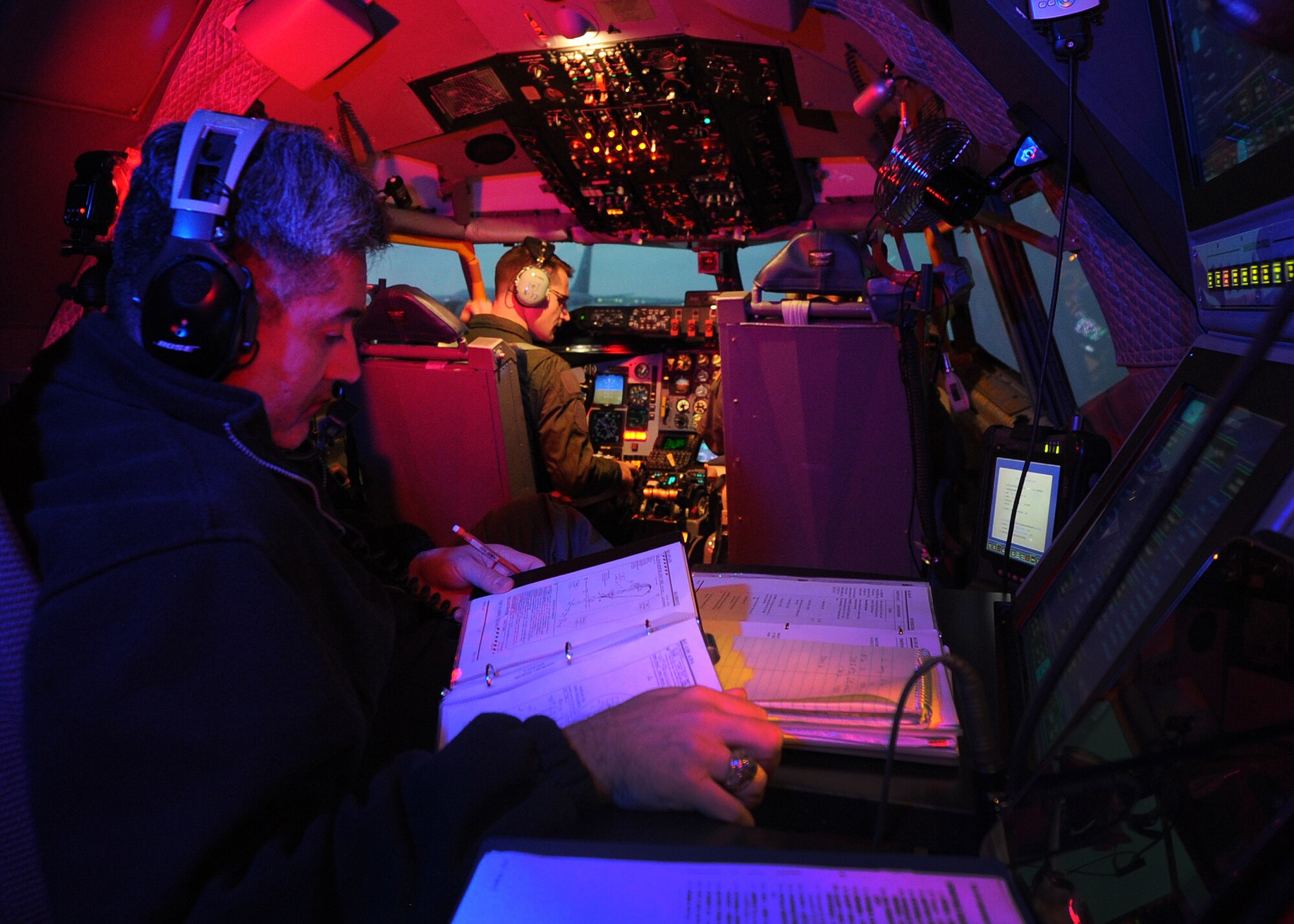 ALTUS AIR FORCE BASE, Okla. – French air force Capt. Aurélien Leray performs a preflight checklist while his instructor, U.S. Air Force Lt. Col. (ret.) Tony Valerio reviews his notes during a simulated flight Nov. 8, 2013. Leray is one of the first French pilots to travel to Altus AFB for training on the KC-135 Stratotanker. (U.S. Air Force photo by Senior Airman Levin Boland/Released)   