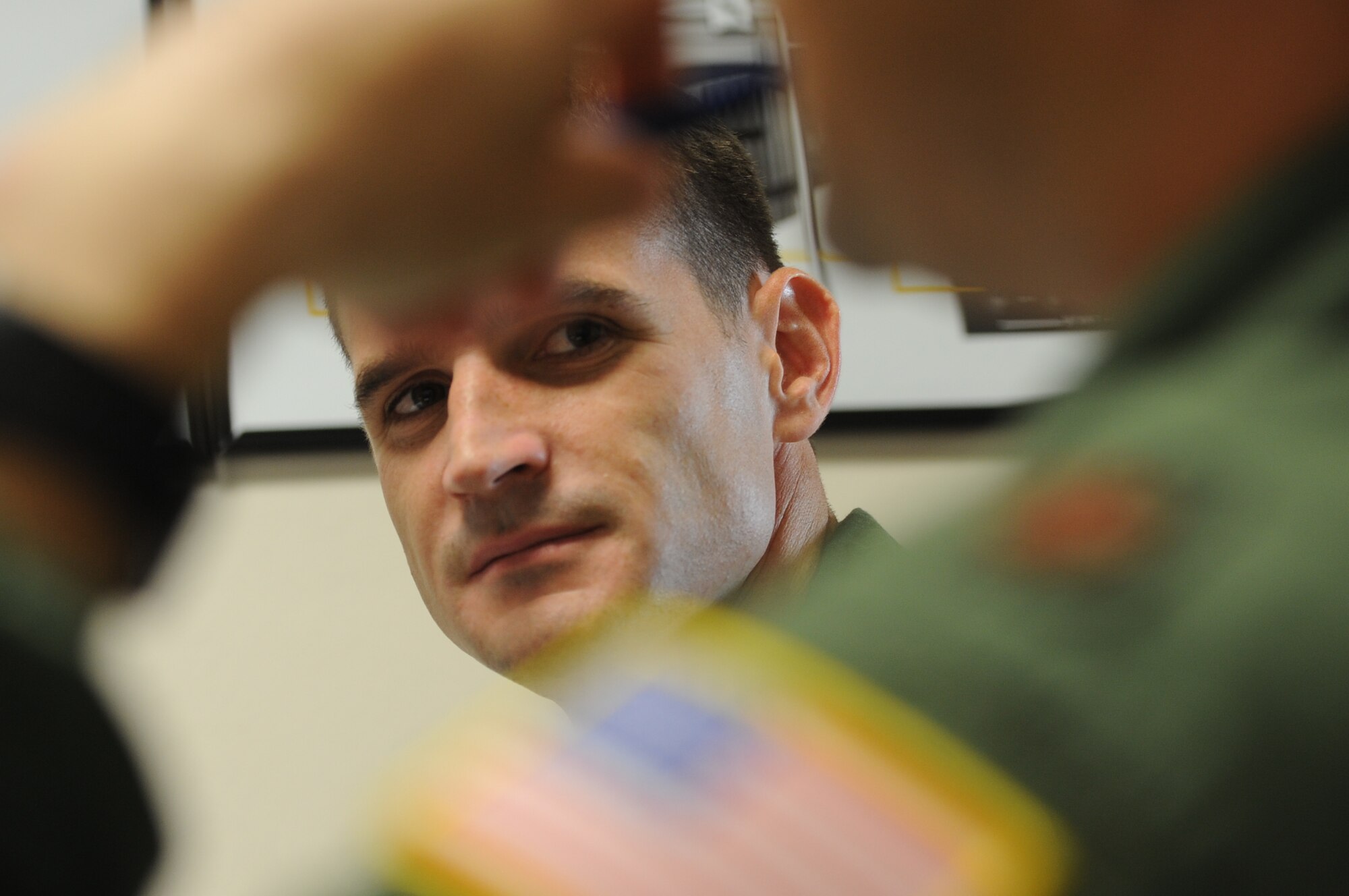 ALTUS AIR FORCE BASE, Okla. – French air force Capt. Aurélien Leray listens to his training partner, U.S. Air Force Maj. Kris Person during a pre-flight briefing for their upcoming simulated flight Oct. 25, 2013. Leray and Person are spending five months training together to fly the KC-135 Stratotanker. (U.S. Air Force photo by Senior Airman Levin Boland/Released) 