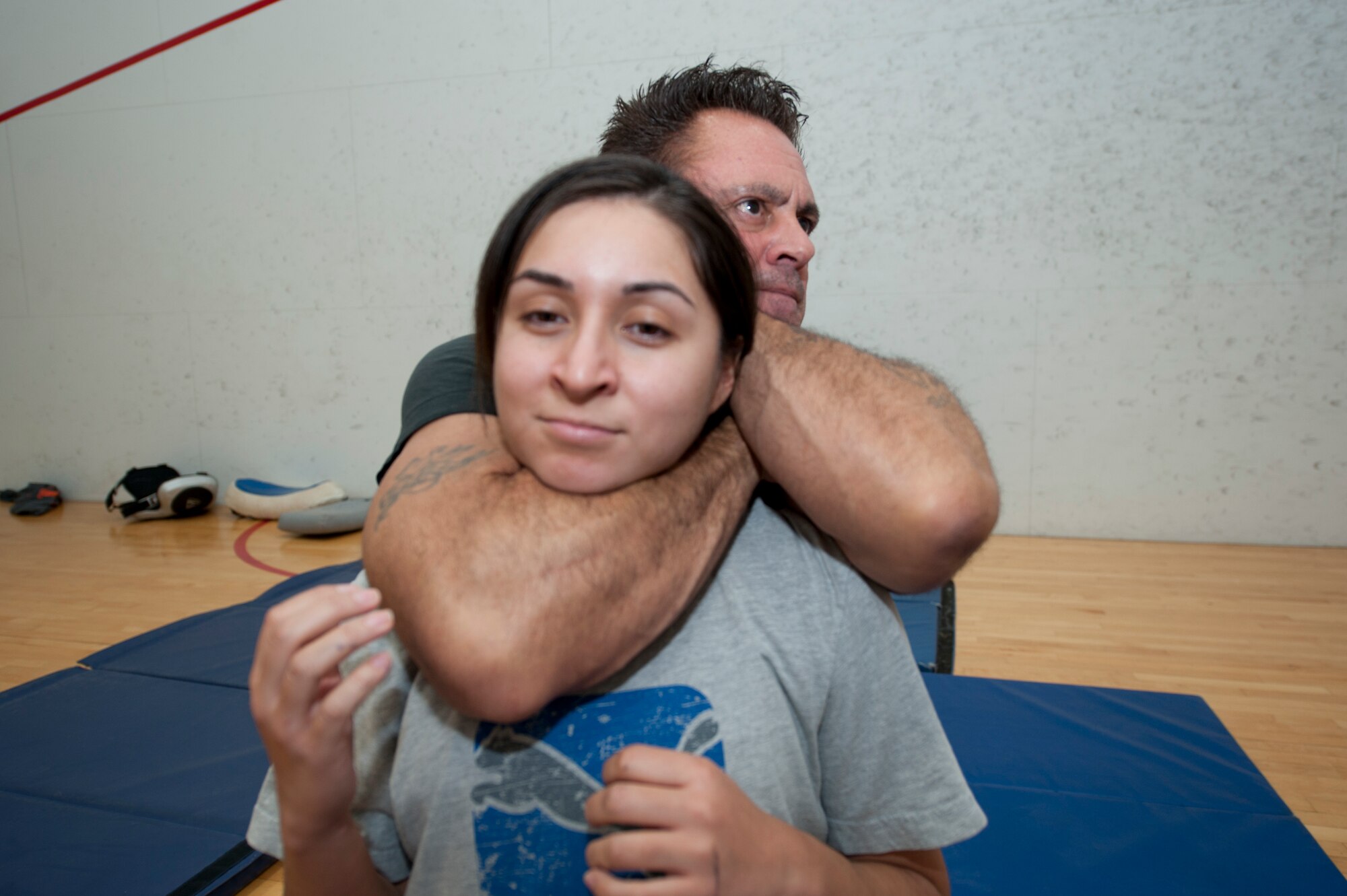 Eddie DeLuca, founder of DeLuca’s Combat Academy, demonstrates a personal defense tactic to Senior Airman Jaimy Porron, 49th Force Support Squadron fitness specialist, at Holloman Air Force Base, N.M., Dec. 19. DeLuca and Roman were providing free hands-on training for an anti-sexual assault, attack and abduction course pioneered by DeLuca.

