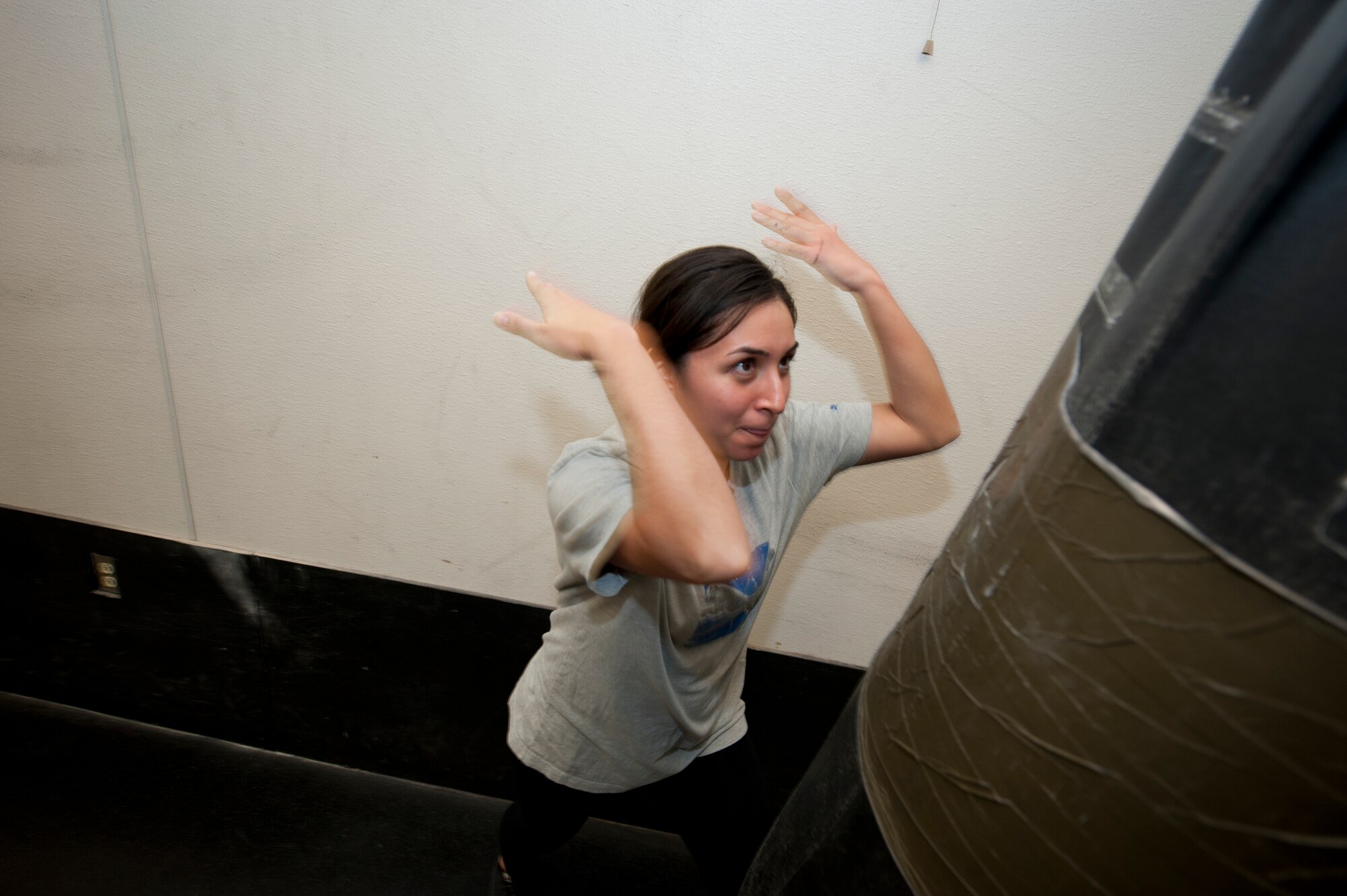 Senior Airman Jaimy Porron, 49th Force Support Squadron fitness specialist, practices a personal defense technique at Holloman Air Force Base, N.M., Dec. 19. DeLuca and Roman were providing free hands-on training for an anti-sexual assault, attack and abduction course pioneered by DeLuca.

