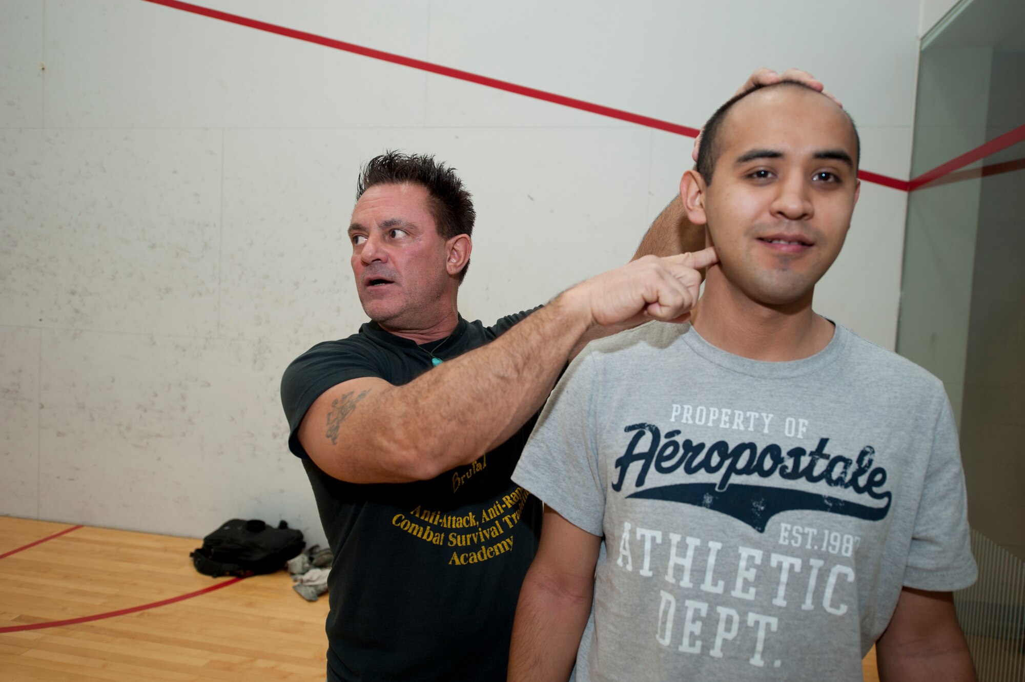 Eddie DeLuca, founder of DeLuca’s Combat Academy, demonstrates a personal defense tactic to Senior Airman Eric Sanchez, 49th Force Support Squadron fitness specialist, at Holloman Air Force Base, N.M., Dec. 19. DeLuca and Roman were providing free hands-on training for an anti-sexual assault, attack and abduction course pioneered by DeLuca.


