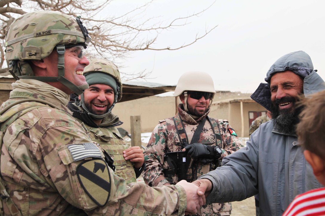 U.S. Army Lt. Col. Winston Brooks meets residents of a village near Bagram Airfield in Afghanistan's Parwan province, Jan. 7, 2014. The meeting enabled U.S. forces to build a better relationship with the people who live outside the base. Brooks is assigned to the 1st Cavalry Division's 3rd Battalion, 82nd Field Artillery Regiment, 2nd Brigade Combat Team.