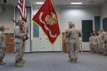 Brig. Gen. Gregg P. Olson, the commanding general, and Sgt. Maj. Mario A. Marquez, the sergeant major, both of Command Element, Marine Forces Central Command (Forward), finish uncasing the unit’s colors during an activation ceremony aboard Naval Support Activity, Bahrain Oct. 3, 2013.