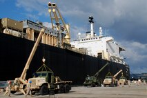 SOUDA BAY, Greece (Sept. 28, 2009) – Marines and sailors of participating units offload and equip MTVRs alongside the USNS 2ndLt. John C. Bobo here as part of Maritime Pre-positioning Force (MPF) Offload 2009.  The exercise is conducted by U.S. Marine Corps Forces Europe in order to test and refine the logistics of providing a robust forward presence in its area of operations.