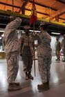 Maj. Sally A. Falco, a Detroit native, receives the company guidon from Maj. Melanie R. Bell-Carter, signifying the passing of duties as the commanding officer of Headquarters Company, United States Marine Corps Forces Central Command (Forward). Marines and sailors aboard Naval Support Activity Bahrain welcome their new commanding officer, Aug. 15 in a change of a command ceremony. 
