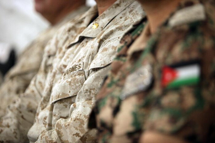 A Marine sits next to his Jordanian counterpart during a brief at Camp Titin, Jordan, June 9, 2013.