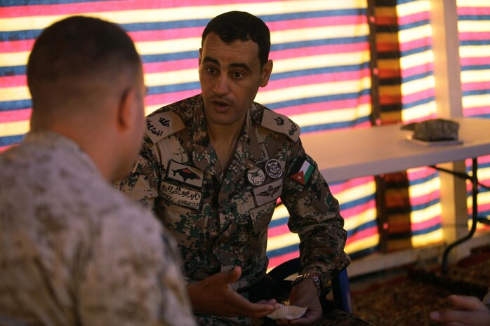 Capt. Joseph J. Endreola, the assistant civil-military operations planner for U.S. Marine Corps Forces Central Command (Forward), and a Roundrock, Texas, native, talks with his counterpart, Maj. Zayed Alkhwalden, the civil affairs officer for the 40th Brigade, Royal Jordanian Armed Forces, on the first day of Exercise Eager Lion 2013 at Camp Titin, Jordan, June 9, 2013.