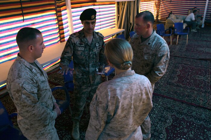 Marines with the civil-military affairs section of U.S. Marine Corps Forces Central Command (Forward) talk to Maj. Zayed Alkhwalden, the civil affairs officer for the 40th Brigade, Royal Jordanian Armed Forces, on the first day of Exercise Eager Lion 2013 at Camp Titin, Jordan, June 9, 2013.
