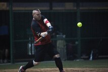 Michael Malone, first baseman, Marine Corps Forces Central Command Forward Team #2 hits the first home run of the season in the third inning of the 2012 Naval Support Activity Bahrain American Softball League season opener, July 15.