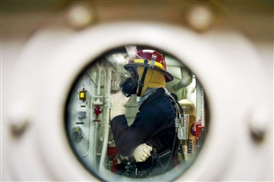 U.S. Navy Petty Officer 3rd Class Christian Davis investigates a space during a general quarters drill aboard the guided missile destroyer USS Stout while underway in the Mediterranean Sea, Jan. 3, 2014. The Stout was on a scheduled deployment supporting maritime security operations and theater security cooperation efforts in the U.S. 6th Fleet area of responsibility. 