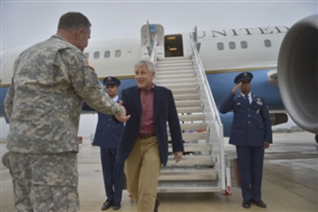 Defense Secretary Chuck Hagel shakes hands with Army Lt. Gen. Perry L. Wiggins, commanding general of U.S. Army North, as he arrives in San Antonio, Jan. 8, 2014, to see Brooke Army Medical Center on Joint Base San Antonio. Hagel also plans to visit military facilities in New Mexico and Wyoming this week to thank wounded warriors, troops and defense workers for their service and dedication.