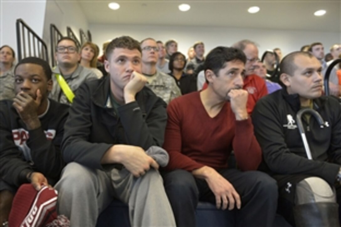 Wounded warriors listen as Defense Secretary Chuck Hagel answers their questions during a town hall meeting at the Center for the Intrepid at Brooke Army Medical Center on Joint Base San Antonio, Jan. 8, 2014. Hagel also plans to visit military facilities in New Mexico and Wyoming this week to thank wounded warriors, troops and defense workers for their service and dedication.