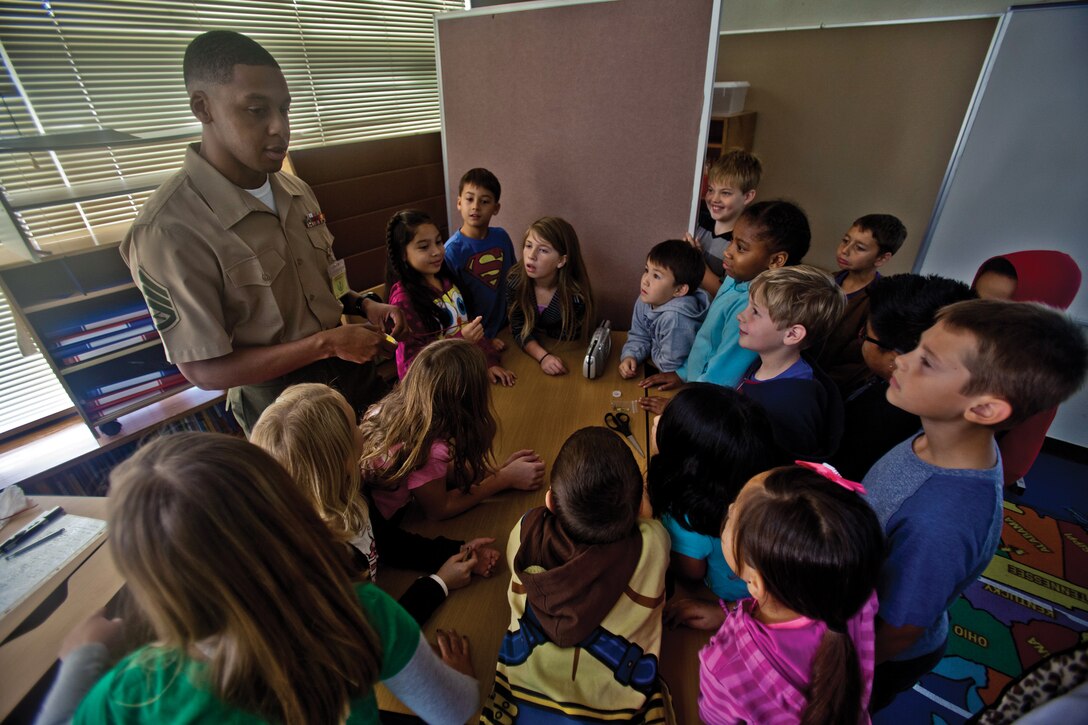Staff Sgt. Herbert M. Grose Jr., teaches students how to build a field expedient antenna as part of the recent Science, Technology, Engineering and Mathematics week at Stearley Heights Elementary School on Kadena Air Base. The students are third-graders at the school. Grose is a signals intelligence specialist with G-2, intelligence, Headquarters Battalion, 3rd Marine Division, III Marine Expeditionary Force. (U.S. Marine Corps photo by Lance Cpl. Diamond N. Peden/Released)