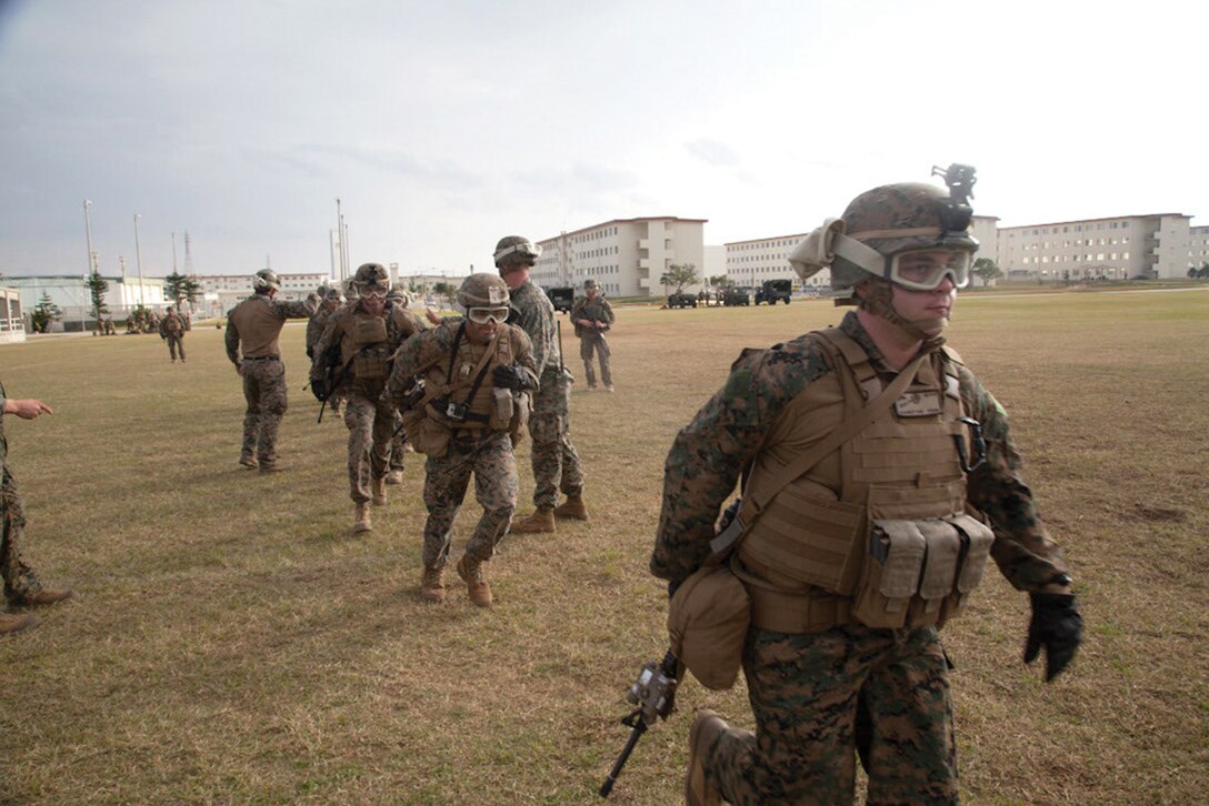 Marines run toward an awaiting CH-53E Super Stallion helicopter Jan. 8 at Camp Hansen. The Marines took part in fast-rope training, where more than 100 Marines familiarized themselves with the essential technique. The Marines are with Battalion Landing Team, 2nd Battalion, 5th Marines, 31st Marine Expeditionary Unit, III Marine Expeditionary Force. (U.S. Marine Corps photo by Cpl. Natalie M. Rostran/Released)