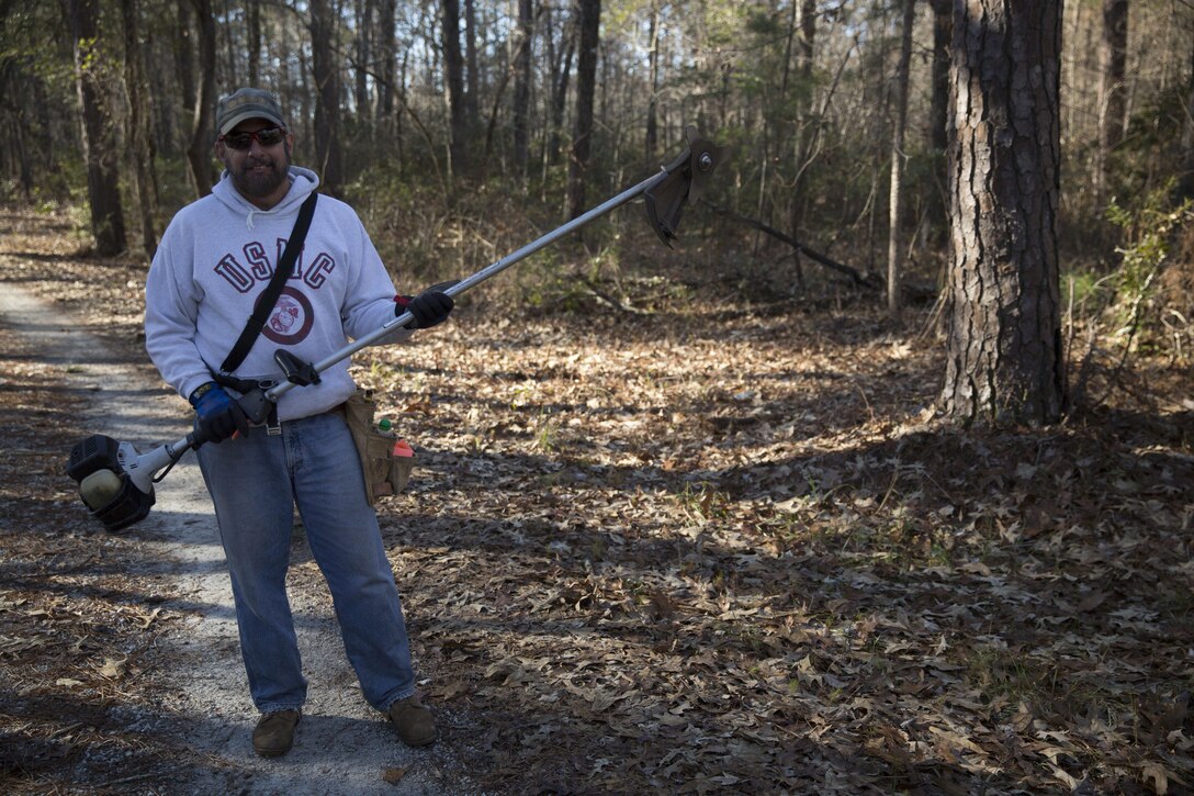 Jeff LeBlanc, a retired master gunnery sergeant and president of Down-East Cyclists, takes a break at the Henderson Recreational Area Trail aboard Marine Corps Base Camp Lejeune. LeBlanc uses the winter months to make improvements and expansion to the bike trail. He began the building process in 2010 and hopes service members and their families will utilize the trail for biking, running and walking.