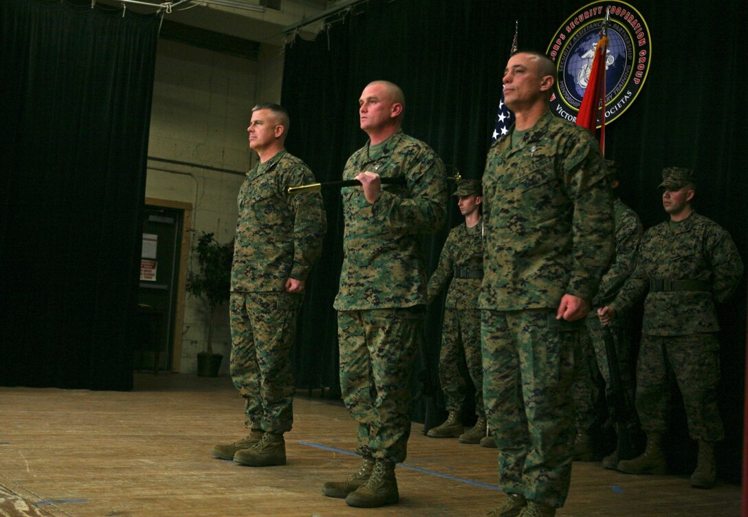 Sgt. Maj. Derek D. Leggett (center), took over as the Marine Corps Security Cooperation Group Sergeant Major from Sgt. Maj. Carl Gantt (right), during a relief and appointment ceremony at the Sandpiper Recreation Center on Joint Expeditionary Base Little Creek-Fort Story, Jan. 9, 2014. During the ceremony, the sword of office was taken from the current sergeant major by the commanding officer, Col. Matt Baker (left), signifying the relinquishing of their duty, and was then given to the incoming sergeant major. The traditional passing of the non-commissioned officer sword symbolizes the transfer of responsibility, knowledge and leadership to the new sergeant major for a unit. 