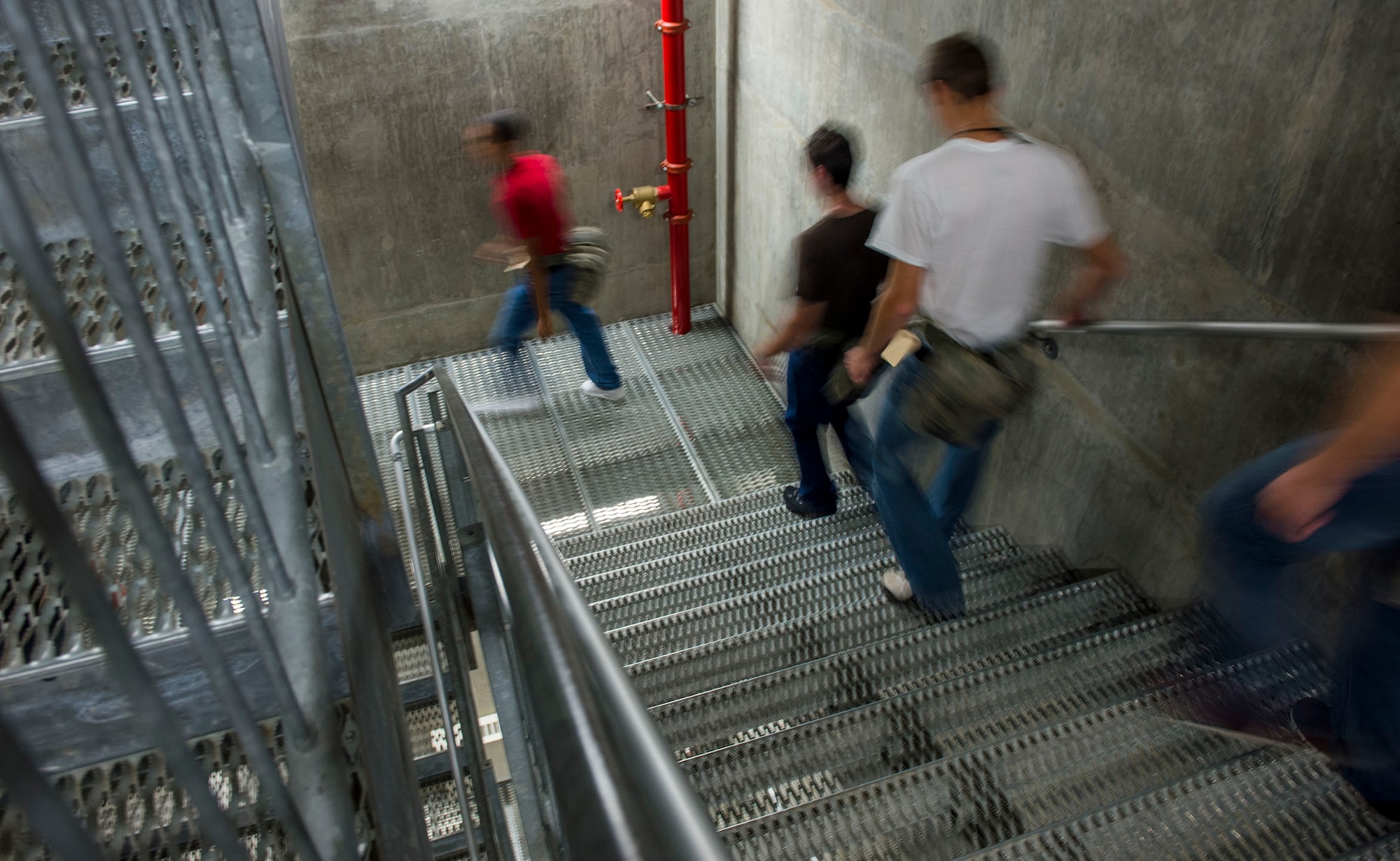 Air Force Basic Military Trainees from the 323rd Training Squadron hurry down stairs at a facility here during the month of October 2013. The Force Protection office at Hanscom AFB, Mass., is working to ensure trainees’ safety with the installation of surveillance systems in common areas to identify personnel coming and going. (U.S. Air Force photo by Airman 1st Class Nathan G. Wilson-Crow)