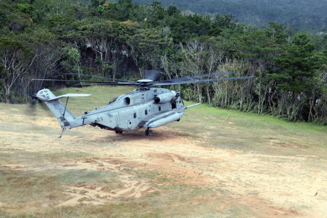 A CH-53E Super Stallion touches down at Landing Zone Falcon Jan. 3 during confined area landing training in the Central Training Area. The helicopter and crew are with Marine Heavy Helicopter Squadron 463, currently assigned to Marine Medium Tiltrotor Squadron 265 (Reinforced), 31st Marine Expeditionary Unit, III Marine Expeditionary Force, under the unit deployment program. (U.S. Marine Corps photo by Lance Cpl. David N. Hersey/Released)