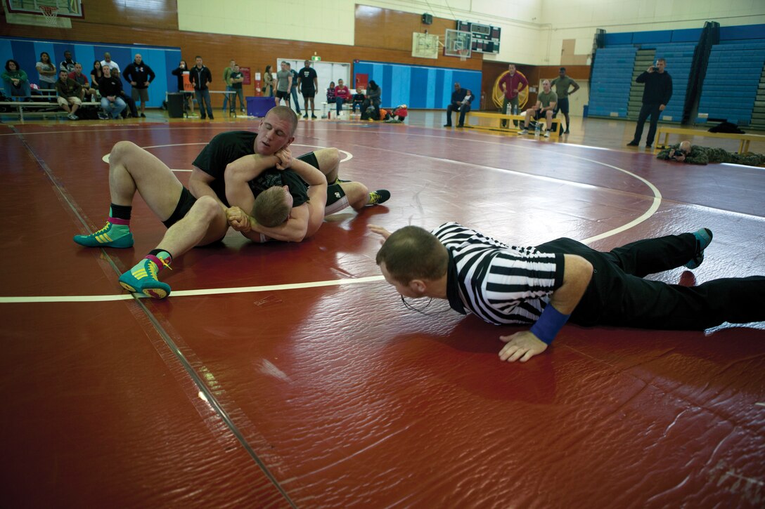140105-M-PJ295-057

MARINE CORPS AIR STATION FUTENMA, OKINAWA, Japan -- Lance Cpl. Matthew G. Kent, left, attempts to pin Tyler J. Putt to the mat during the Futenma Athletics Open Wrestling Tournament Jan. 4 at Marine Corps Air Station Futenma’s Semper Fit Gym. The wrestling style designated for the tournament was freestyle, where the wrestlers are on their feet more often and try to pin their opponent to the mat. Once both shoulder blades touch the mat, the bout is over. Kent is a rifleman with 2nd Battalion, 5th Marine Regiment, currently assigned 4th Marine Regiment, 3rd Marine Division, III MEF, under the UDP. Putt is a college student. (U.S. Marine Corps photo by Lance Cpl. Diamond N. Peden/Released)