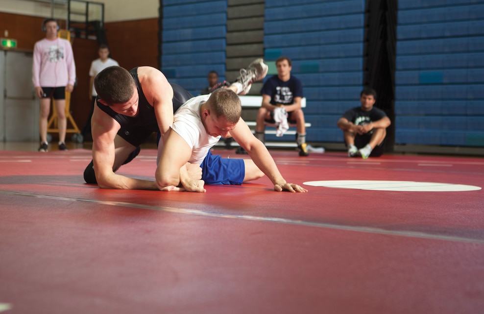Lance Cpl. Philip A. Rickenbach, right, locks Bryan S. Caldwell’s arm in a hold Jan. 4 during the Futenma Athletics Open Wrestling Tournament at Marine Corps Air Station Futenma’s Semper Fit Gym. The referees used the International Federation of Associated Wrestling Styles as their rulebook and guide to supervise and score the tournament, which was sponsored by Marine Corps Community Services. Caldwell is a maintenance worker for Shogun Inn at Kadena Lodging. Rickenbach is an aerial gunner with Marine Heavy Helicopter Squadron 463, Marine Aircraft Group 24, 1st Marine Aircraft Wing, currently assigned to Marine Medium Tiltrotor Squadron 265 (Reinforced), 31st Marine Expeditionary Unit, III Marine Expeditionary Force, under the unit deployment program. (U.S. Marine Corps photo by Lance Cpl. Diamond N. Peden/Released)
