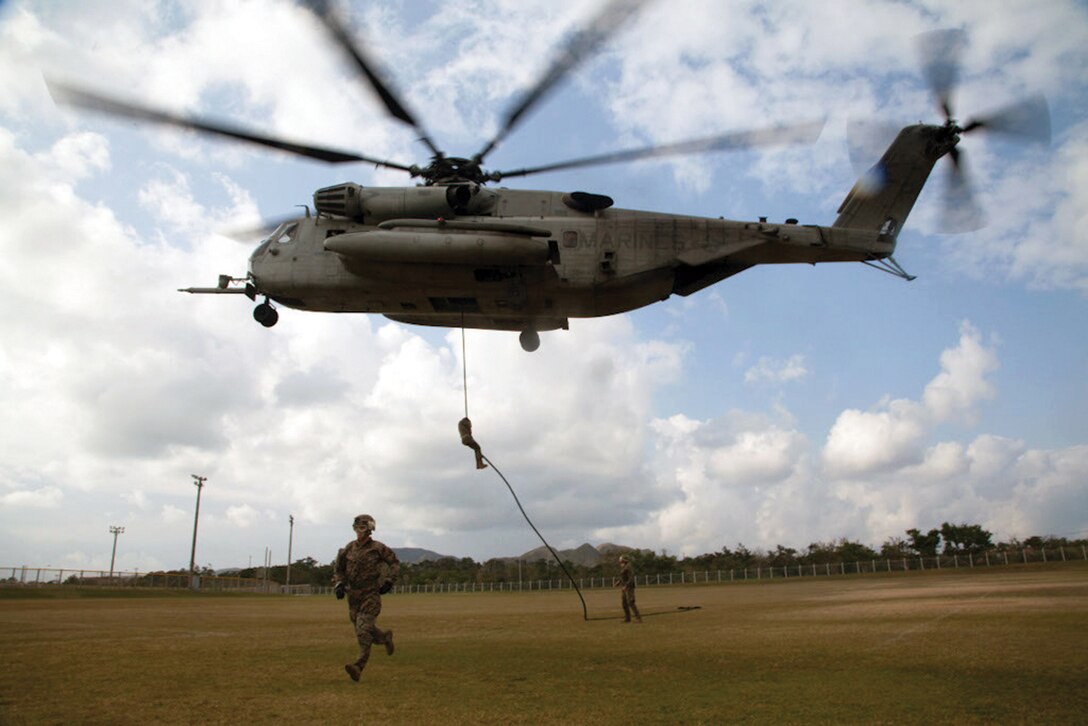 Marines practice their fast-roping techniques Jan. 8 at Camp Hansen. The Marines fast-roped down from a CH-53E Super Stallion helicopter in a precision hover at 30 feet. More than 100 infantrymen completed two iterations, one with minimal equipment and the second with full packs and weapons. The Marines are with  2nd Battalion, 5th Marine Regiment, currently assigned to the 31st Marine Expeditionary Unit, III Marine Expeditionary Force. The helicopter and crew are with Marine Heavy Helicopter Squadron 463, currently assigned to Marine Medium Tiltrotor Squadron 265 (Reinforced), 31st MEU, III MEF. (U.S. Marine Corps photo by Cpl. Natalie M. Rostran/Released)
