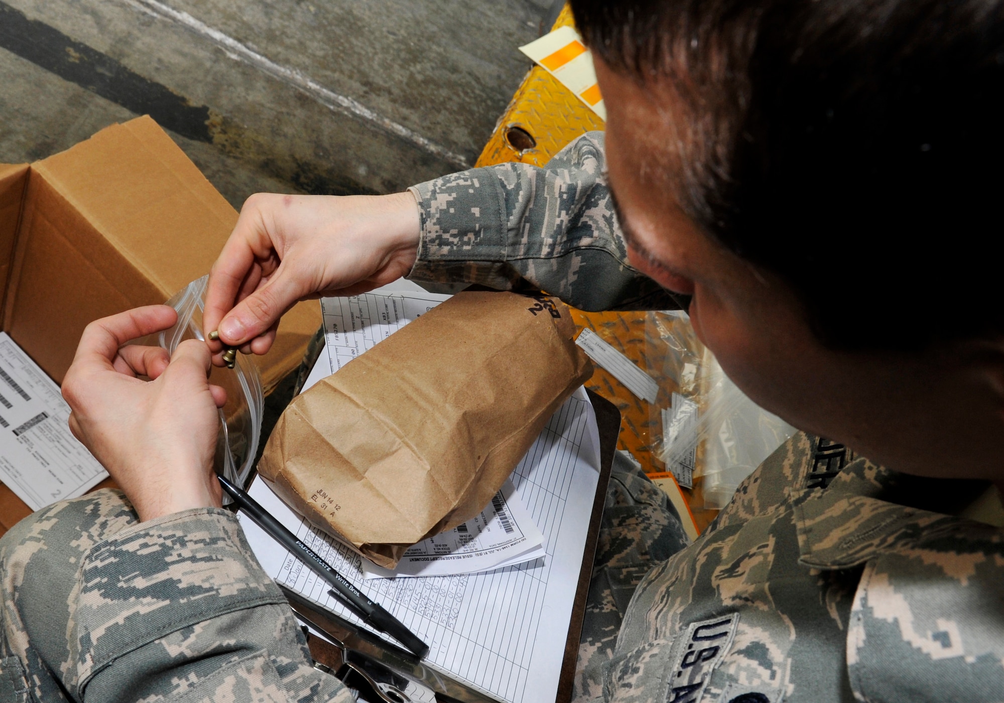 U.S. Air Force Airman Zachary Vasbinder, 18th Logistic Readiness Squadron northside aircraft part store apprentice, places screws into bags in preparation for an upcoming inspection on Kadena Air Base, Japan, Jan. 8, 2014. The 18th LRS northside aircraft part store manages parts and ensures they are secure and safe once placed at their warehouse. (U.S. Air Force photo by Naoto Anazawa)