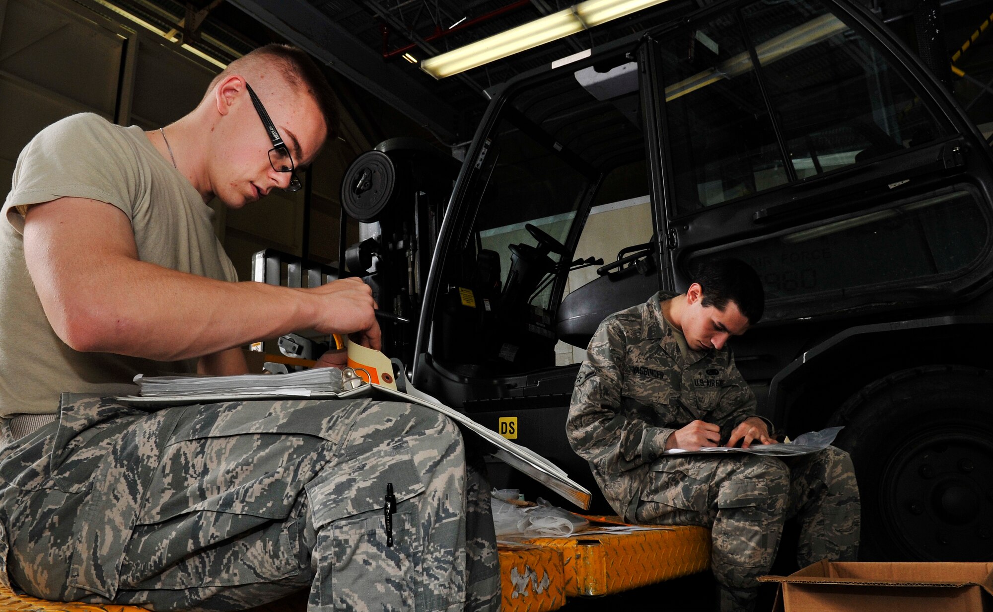 U.S. Air Force Airman 1st Class Alexander Hubbard and Airman Zachary Vasbinder, 18th Logistic Readiness Squadron northside aircraft part store apprentices, log serial numbers of aircraft parts in preparation for an upcoming inspection on Kadena Air Base, Japan, Jan. 8, 2014. The northside aircraft part store apprentices ensure aircraft parts are properly stored and remain in an issuable state. This is particularly important when repairing and maintaining mission critical assets, where time can make the difference between mission failure or success. (U.S. Air Force photo by Naoto Anazawa)