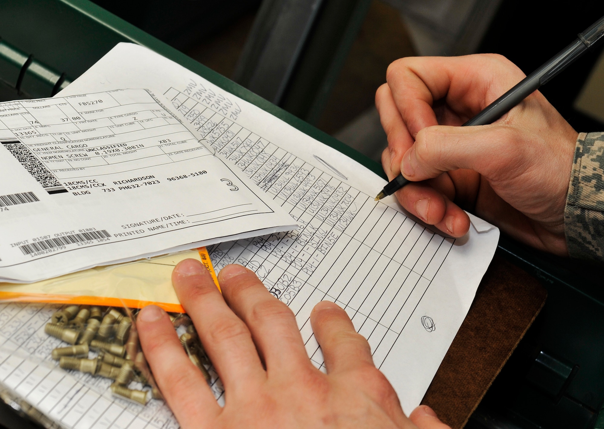 U.S. Air Force Airman Zachary Vasbinder, 18th Logistic Readiness Squadron northside aircraft part store apprentice, logs serial numbers of aircraft screws in preparation for an upcoming inspection on Kadena Air Base, Japan, Jan. 8, 2014. The 18th LRS northside aircraft part store manages spare packages for the staging area for delivery of items.  (U.S. Air Force photo by Naoto Anazawa)