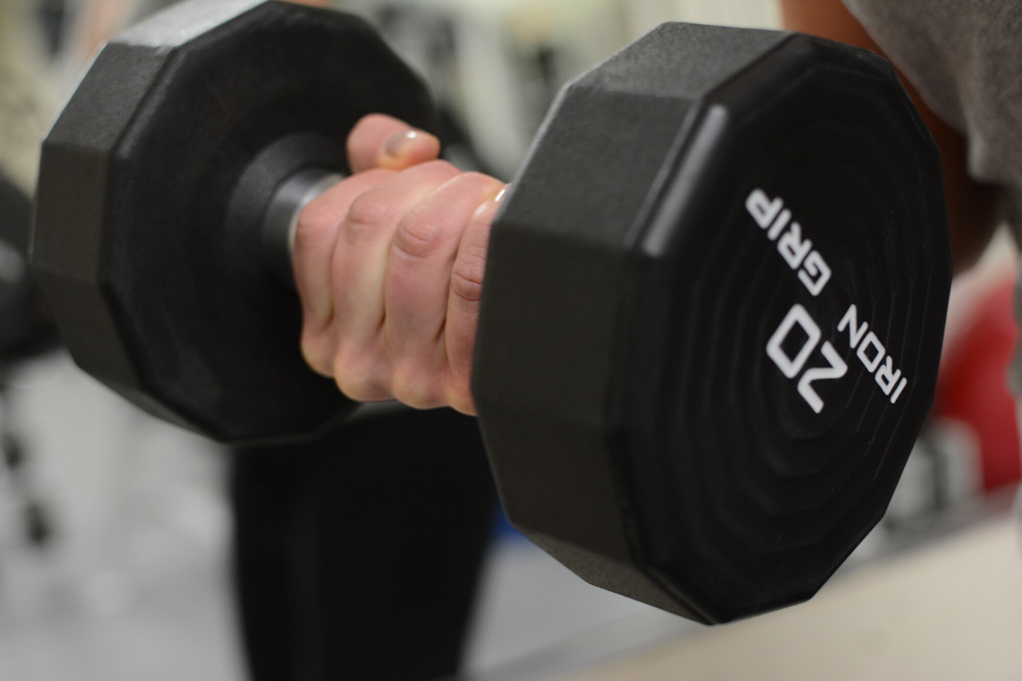 1st Lt. Angie Hellenbrand, 115th Fighter Wing Fitness Working Group member, lifts a weight at the base gym on Truax Field, Madison, Wis., Jan. 9. Hellenbrand joined the Fitness Working Group to help Airmen succeed with their fitness goals. (Air National Guard photo by Senior Airman Andrea F. Liechti)